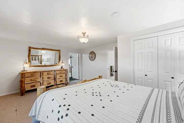 Recessed lighting, wood-finish flooring, white walls, and built-in closet storage