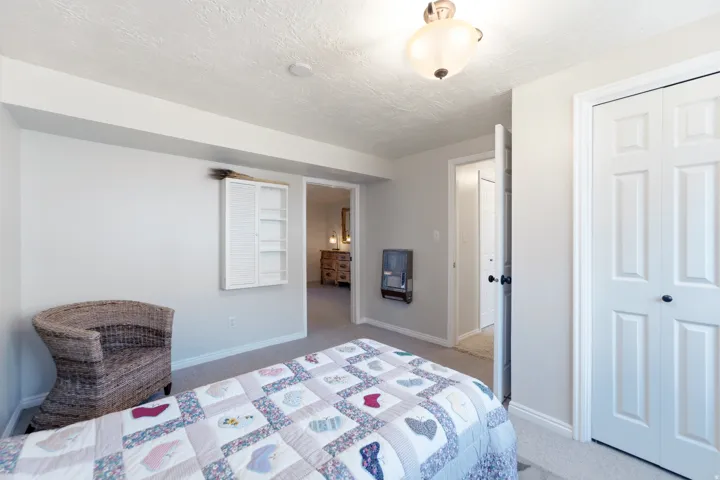 Carpeted flooring, paneled bifold closet doors, and recessed lighting