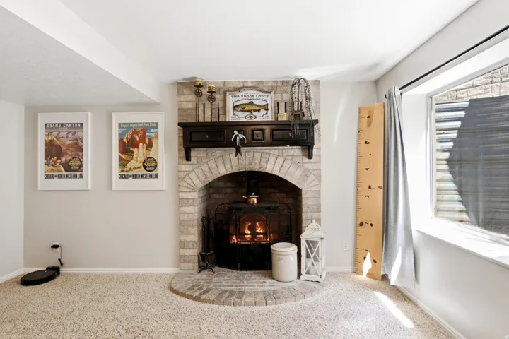 Brick fireplace with a wood-burning insert and an arched opening
