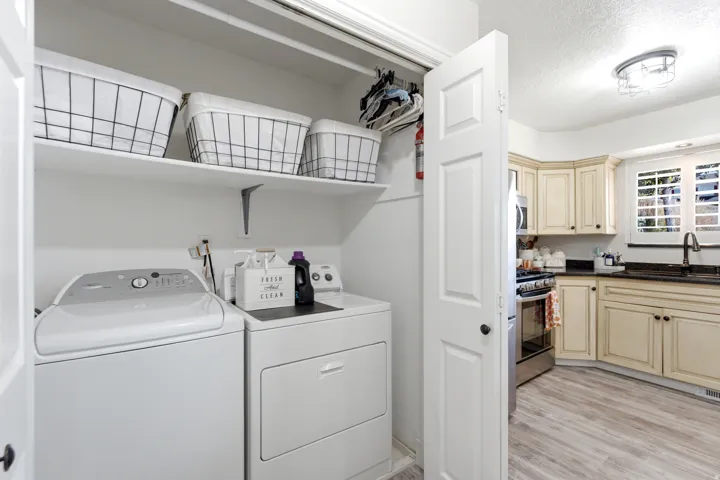 Laundry closet with built-in shelving and hanging rod