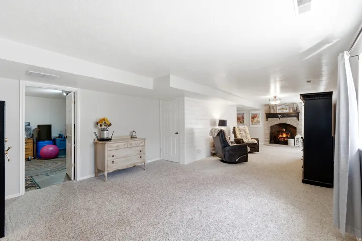 Spacious room featuring light-toned carpeting and white walls