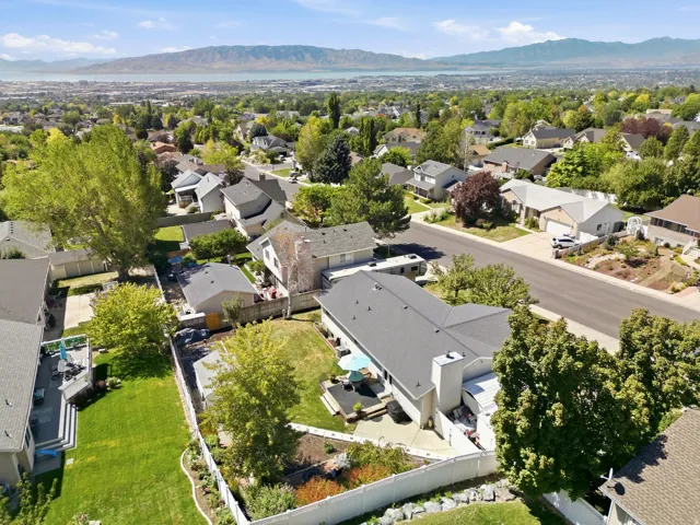 Expansive residential area featuring established homes, mature trees, and mountainous scenery
