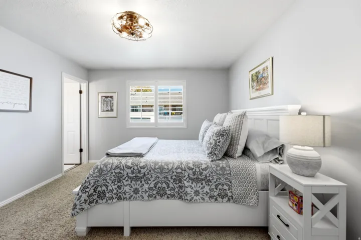 Built-in window shutters, paneled interior door, and ceiling-mounted light fixture