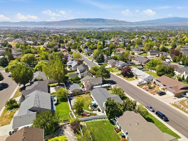 Residential neighborhood with mature trees and a distant body of water