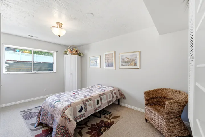 Recessed window with white trim, wall-mounted light fixture, and light-colored carpeting