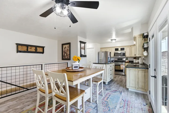 Kitchen with cream cabinetry, dark countertops, a central island, and stainless steel appliances