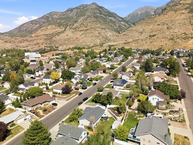 Residential neighborhood with mature trees and mountain scenery