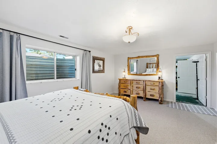 Wall-to-wall carpeting and white walls with a ceiling-mounted light fixture