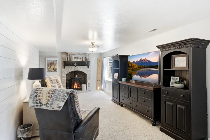 Stone-faced fireplace with brick arch, built-in mantel, and hearth
