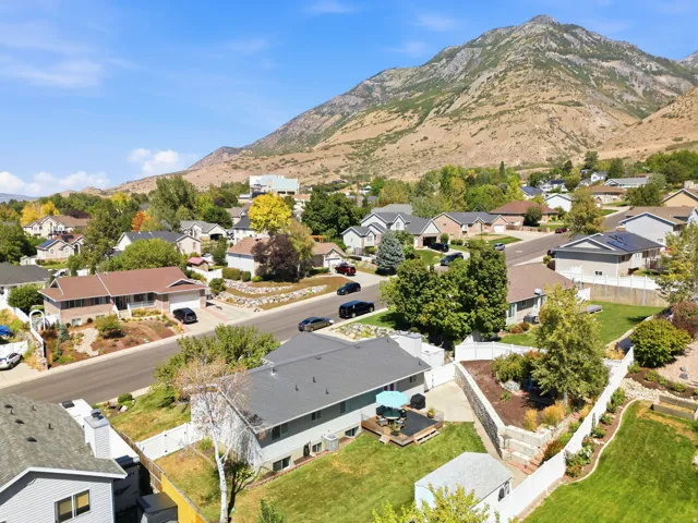 Expansive mountain backdrop with a residential neighborhood featuring diverse architectural styles