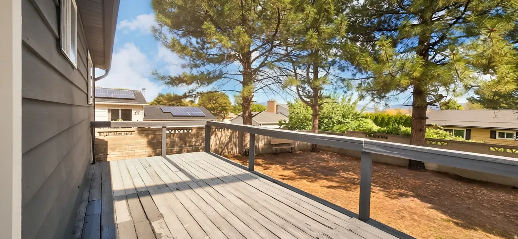 Spacious outdoor deck with railings, offering an expansive outdoor living area