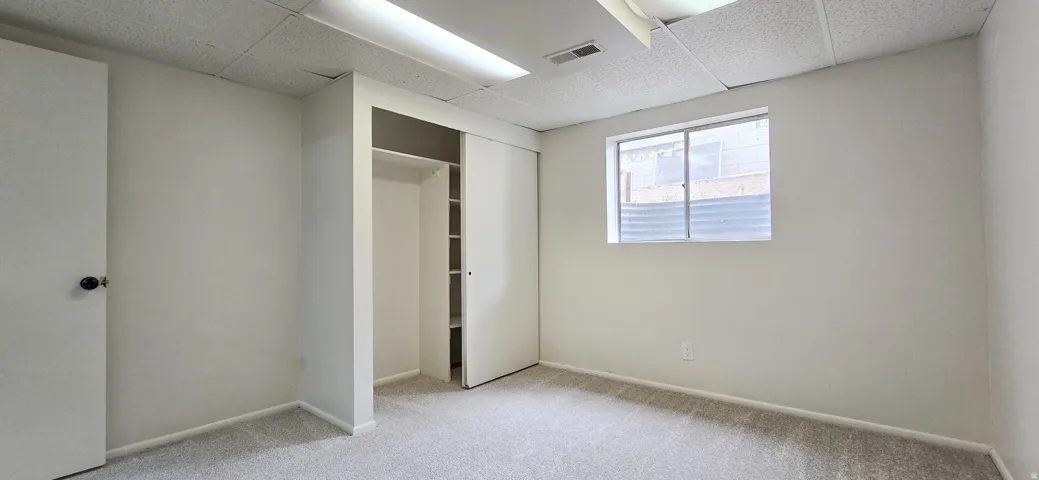Wall-to-wall carpeting and a neutral color palette