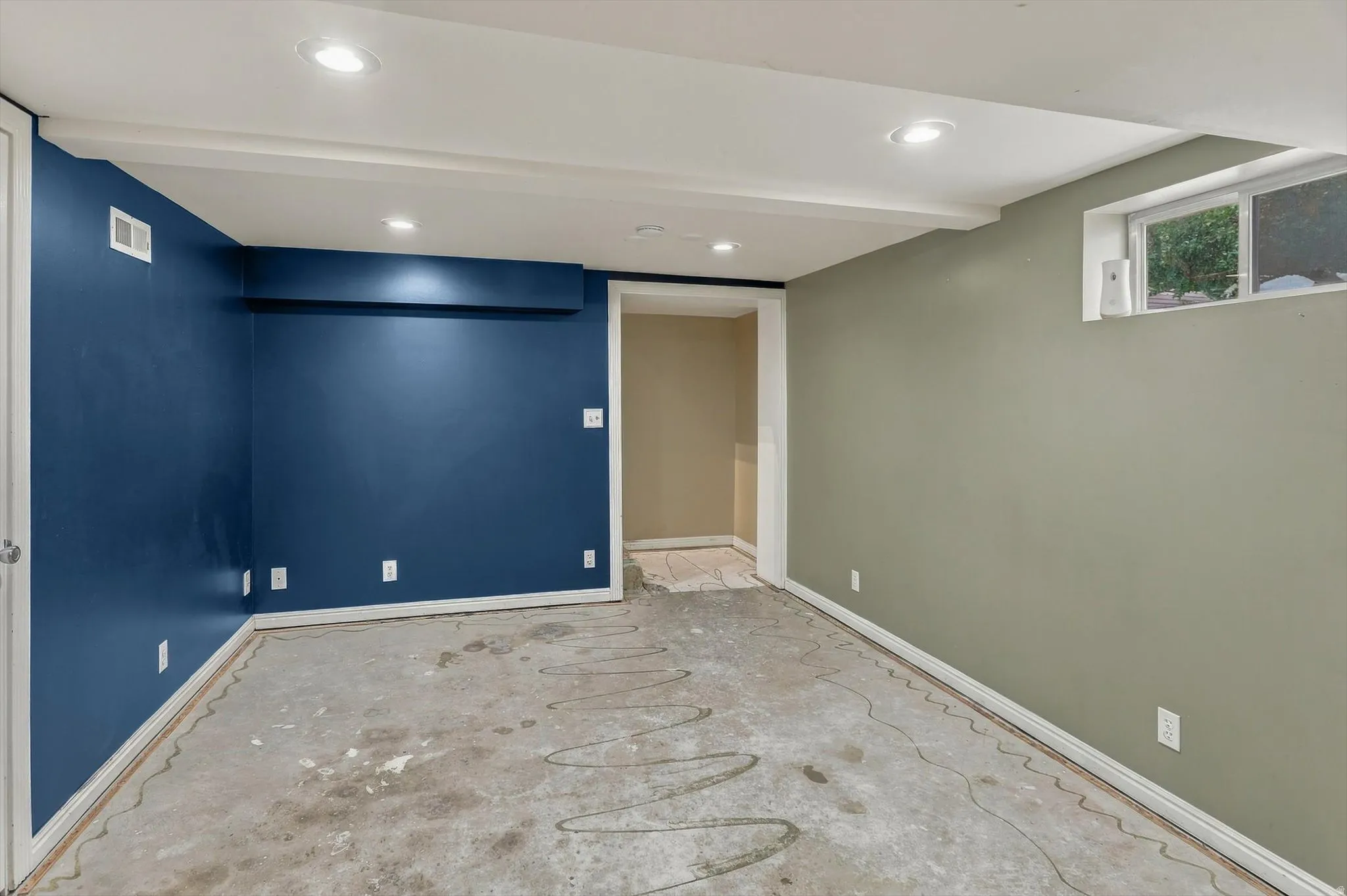 Recessed lighting, painted walls, white trim, and a window opening
