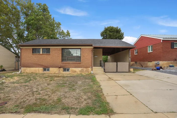 Brick exterior with a dark-shingle roof