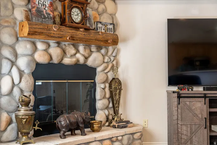 Stone fireplace surround with a natural wood mantel