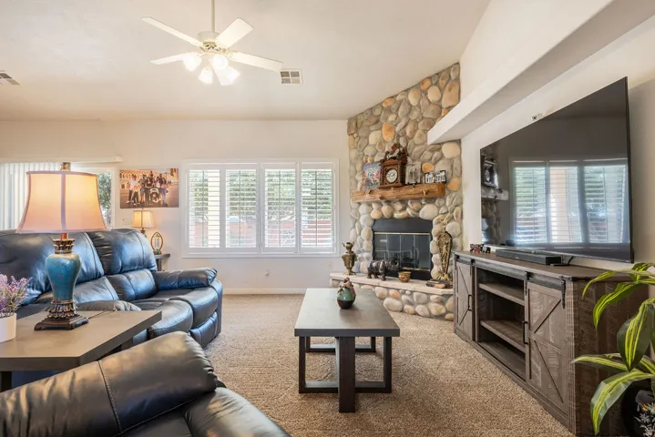 River rock fireplace with a wood-beam mantel