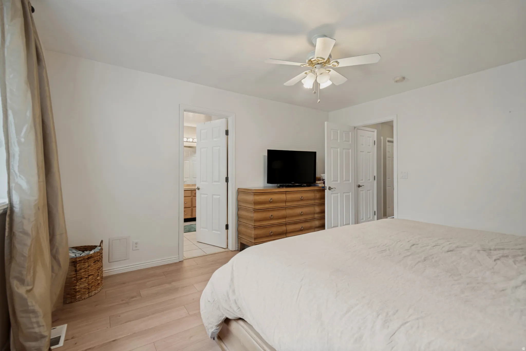 Recessed lighting, ceiling fan light fixture, wood-finish flooring, and white paneled doors