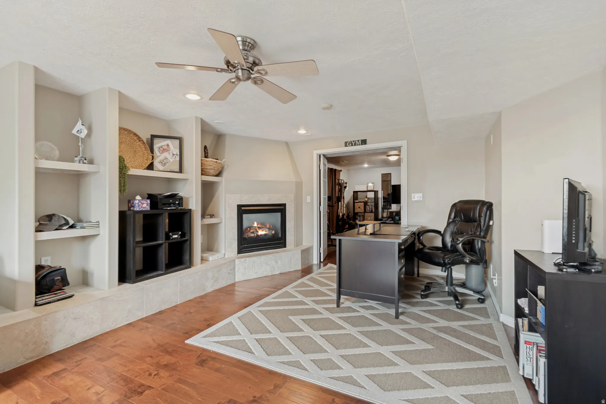 Warm wood-finish flooring with recessed lighting