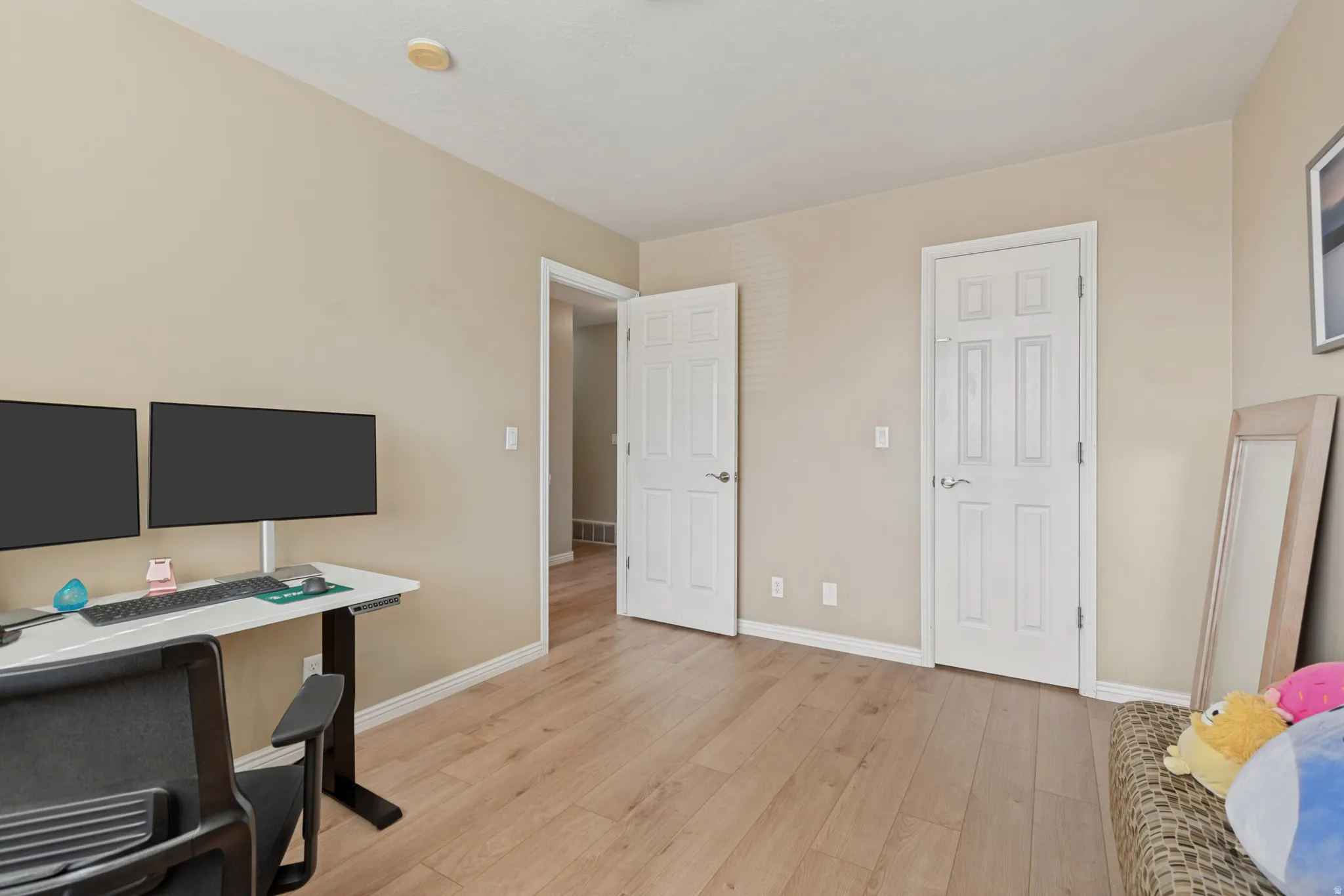 Light-toned wood-finish flooring throughout