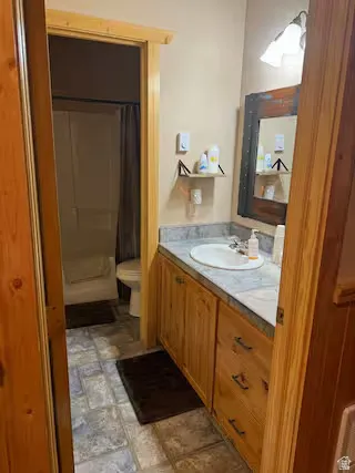 Wood-finish vanity with a built-in sink and countertop