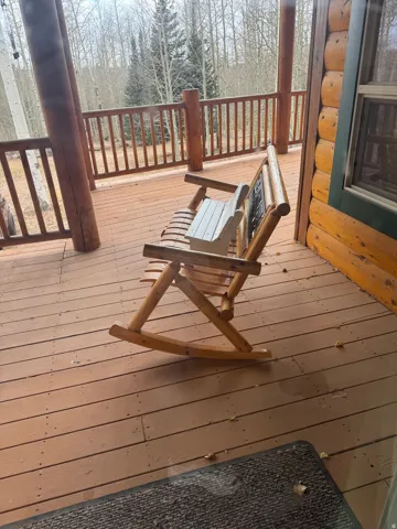 Wood deck with a log railing and substantial log posts