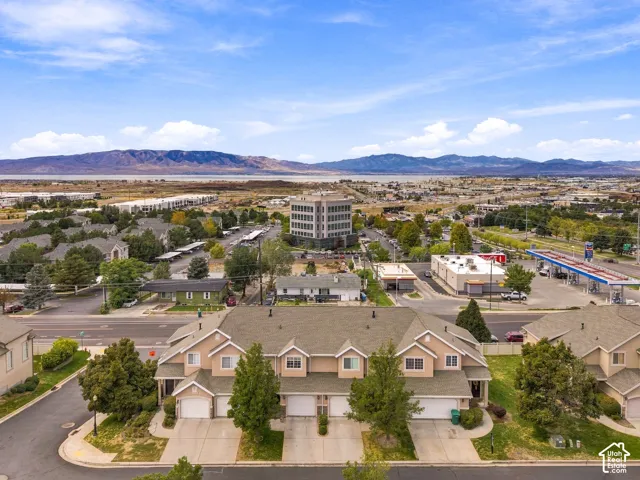 Townhome-style residences with attached garages and driveway parking, featuring pitched roofs and dormer windows