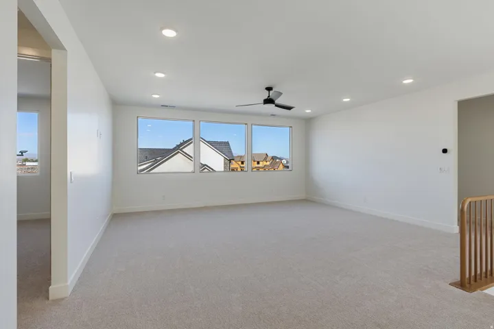 Expansive Family Room/Loft featuring plush carpet flooring, recessed ceiling lighting, and a ceiling fan