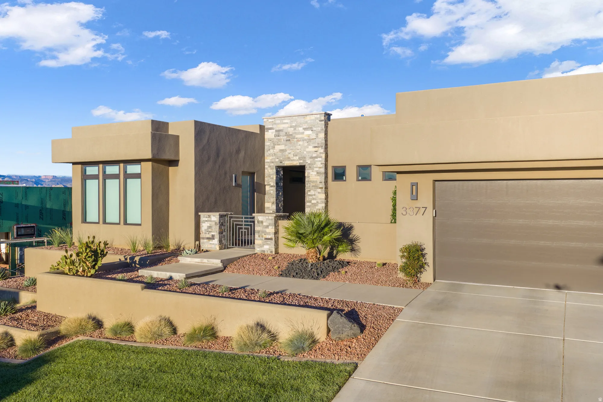 Contemporary stucco exterior with stone accents
