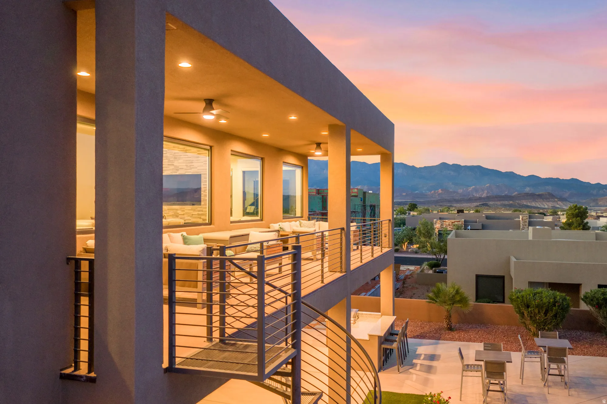 Covered balcony with recessed lighting, ceiling fans, and metal railings