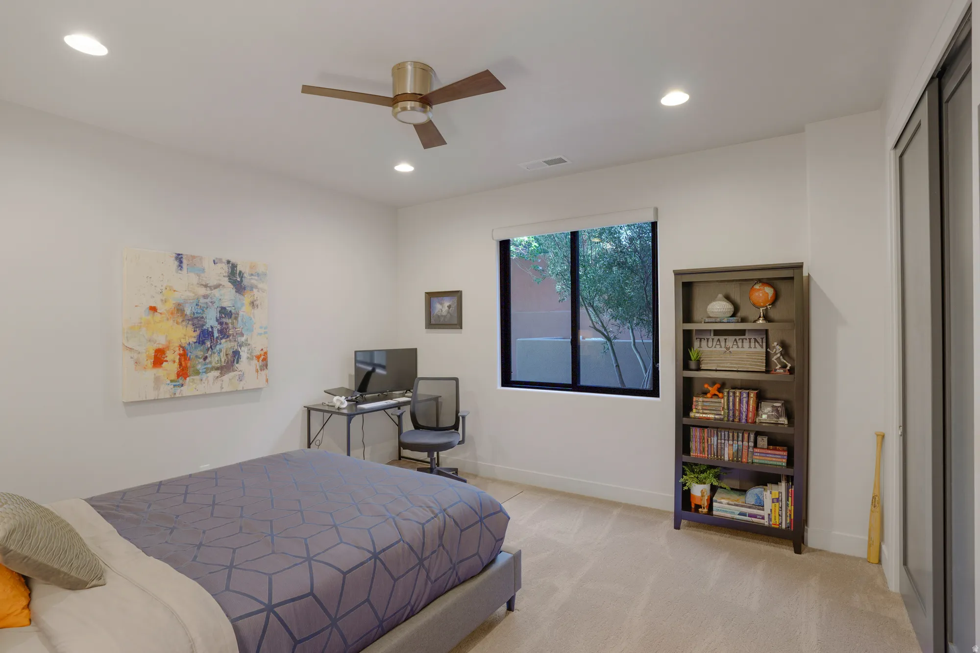 Recessed lighting, ceiling fan, window with exterior landscaping, built-in shelving, and carpeted flooring
