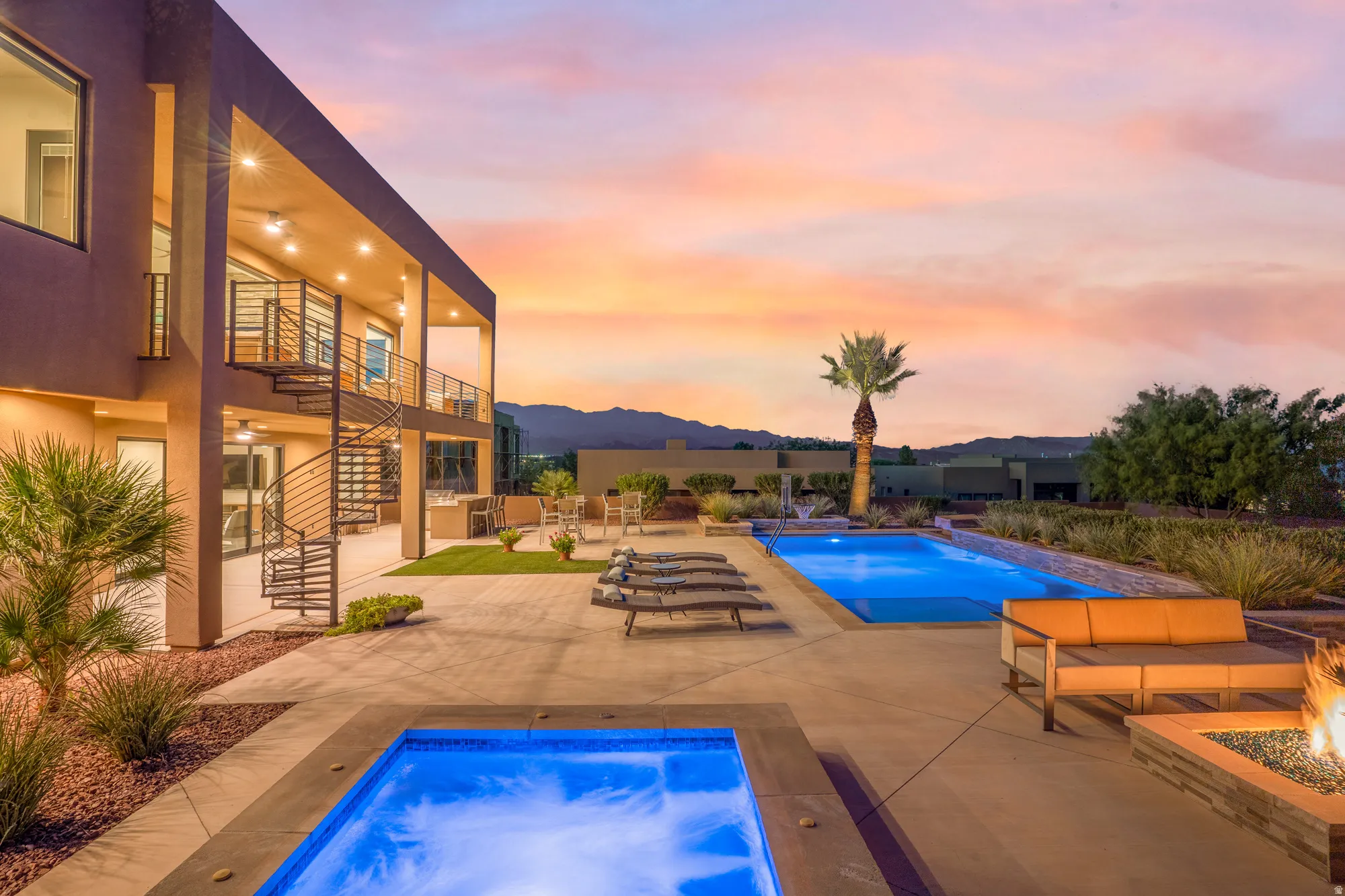 Expansive concrete patio featuring two pools, a spa, and a built-in fire pit