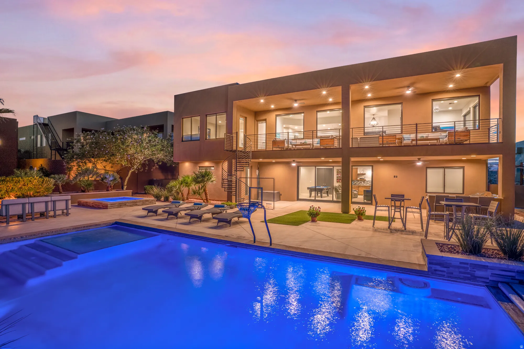 Contemporary exterior with a large swimming pool, integrated spa, and two levels of covered outdoor living spaces