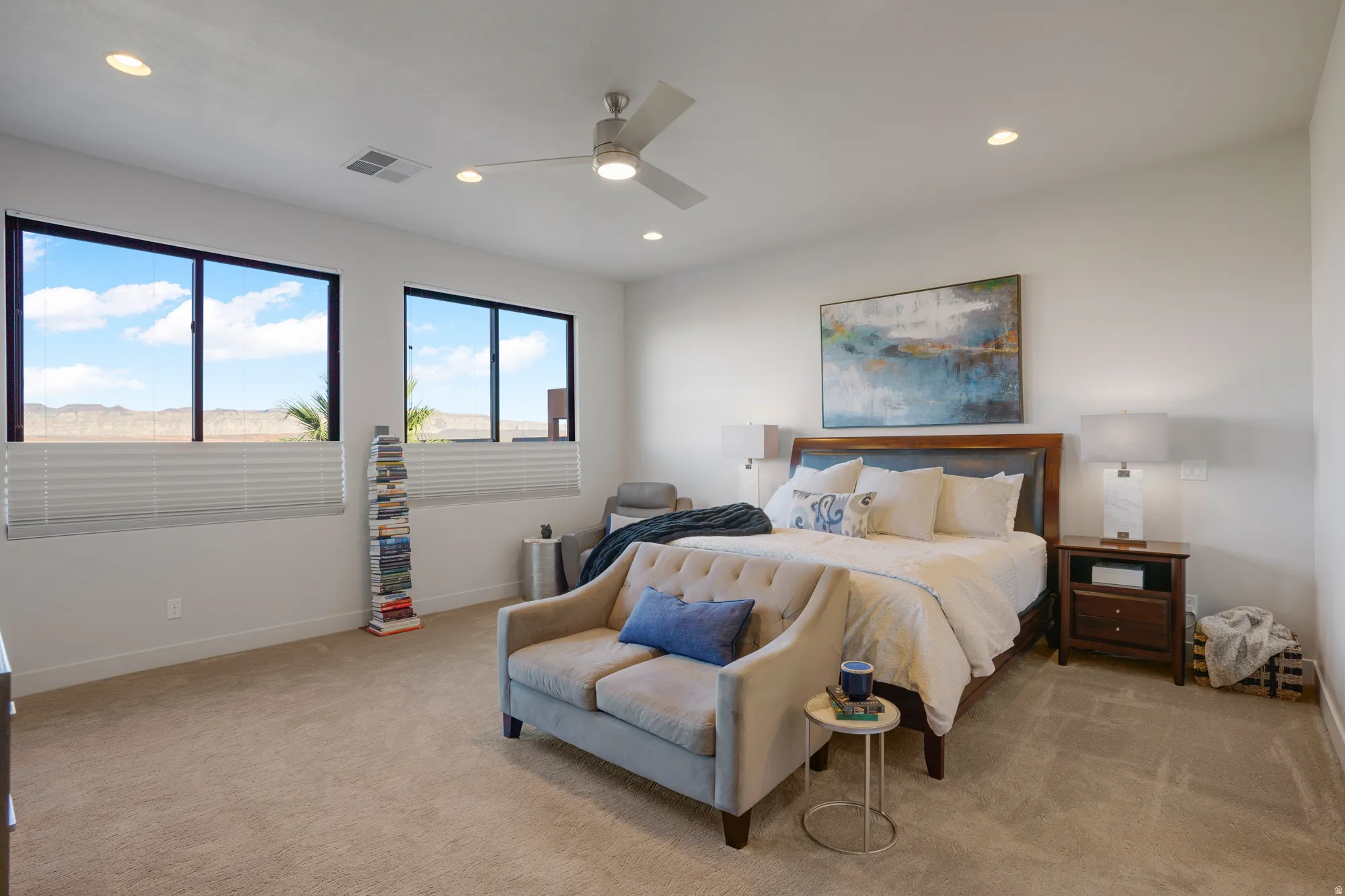 Expansive room with large windows, recessed lighting, and a ceiling fan