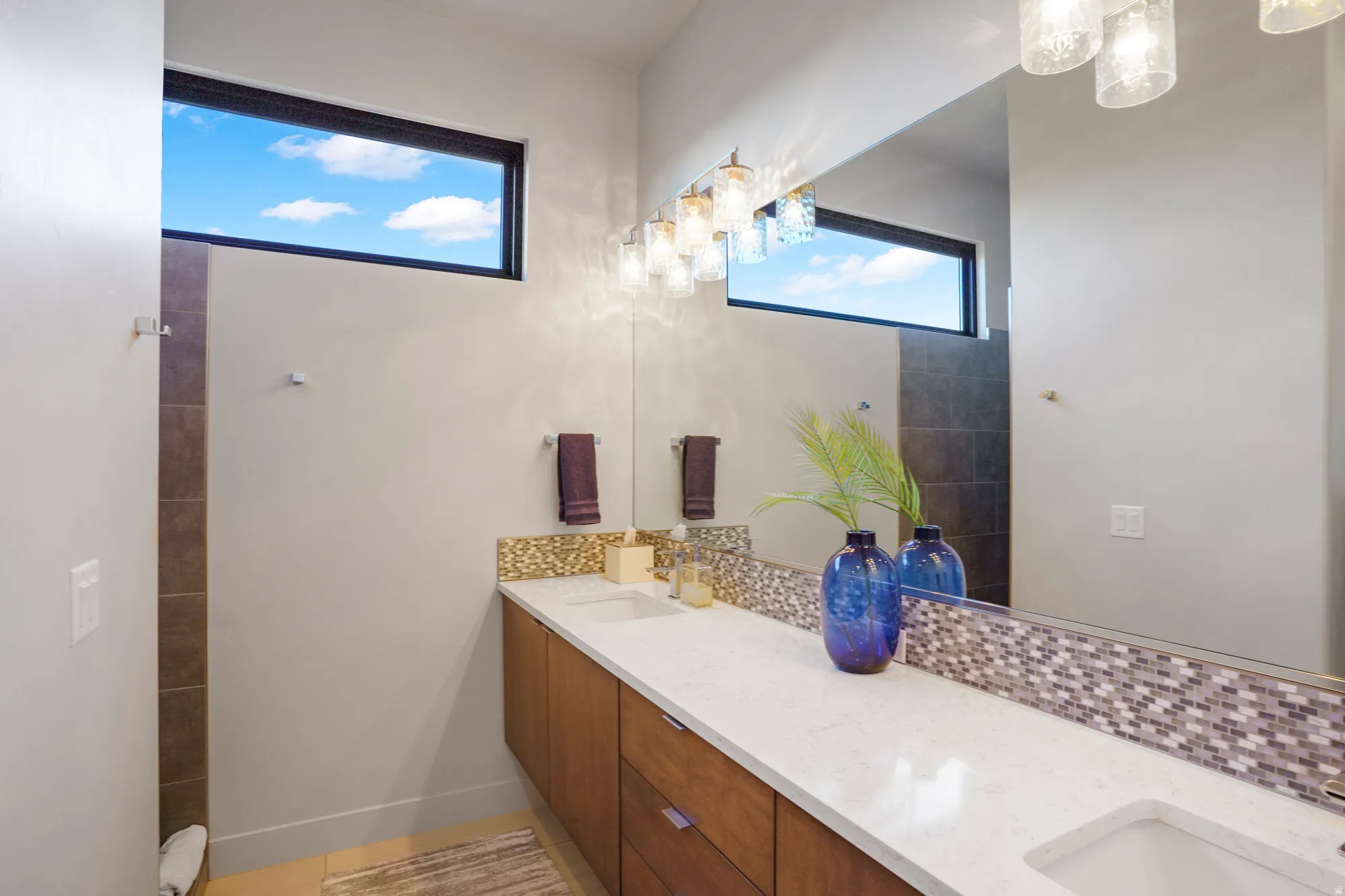 Dual vanity with undermount sinks, white countertop, and wood-finish cabinetry