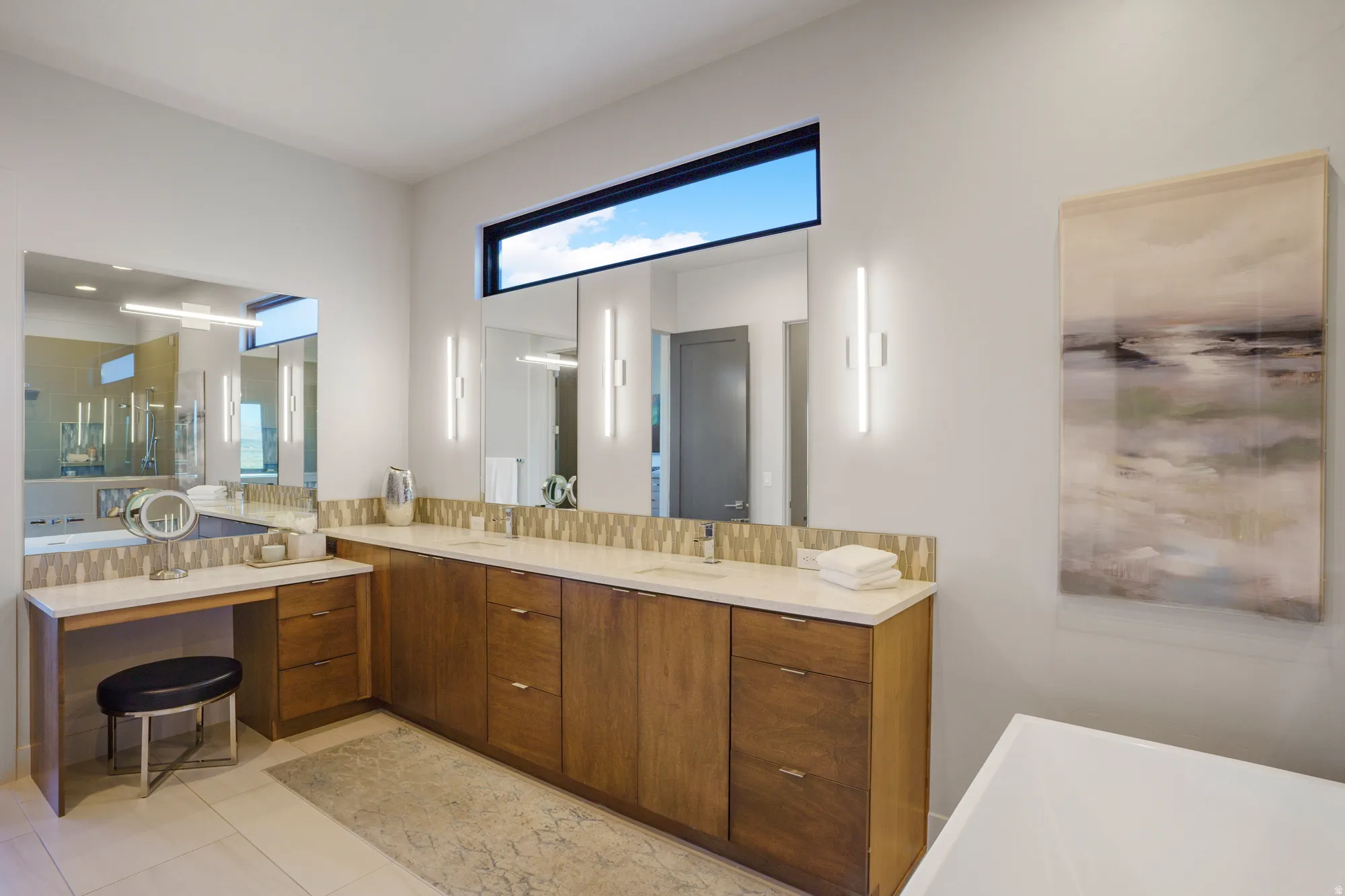 Dual wood-finish vanity with integrated sinks and stone countertops