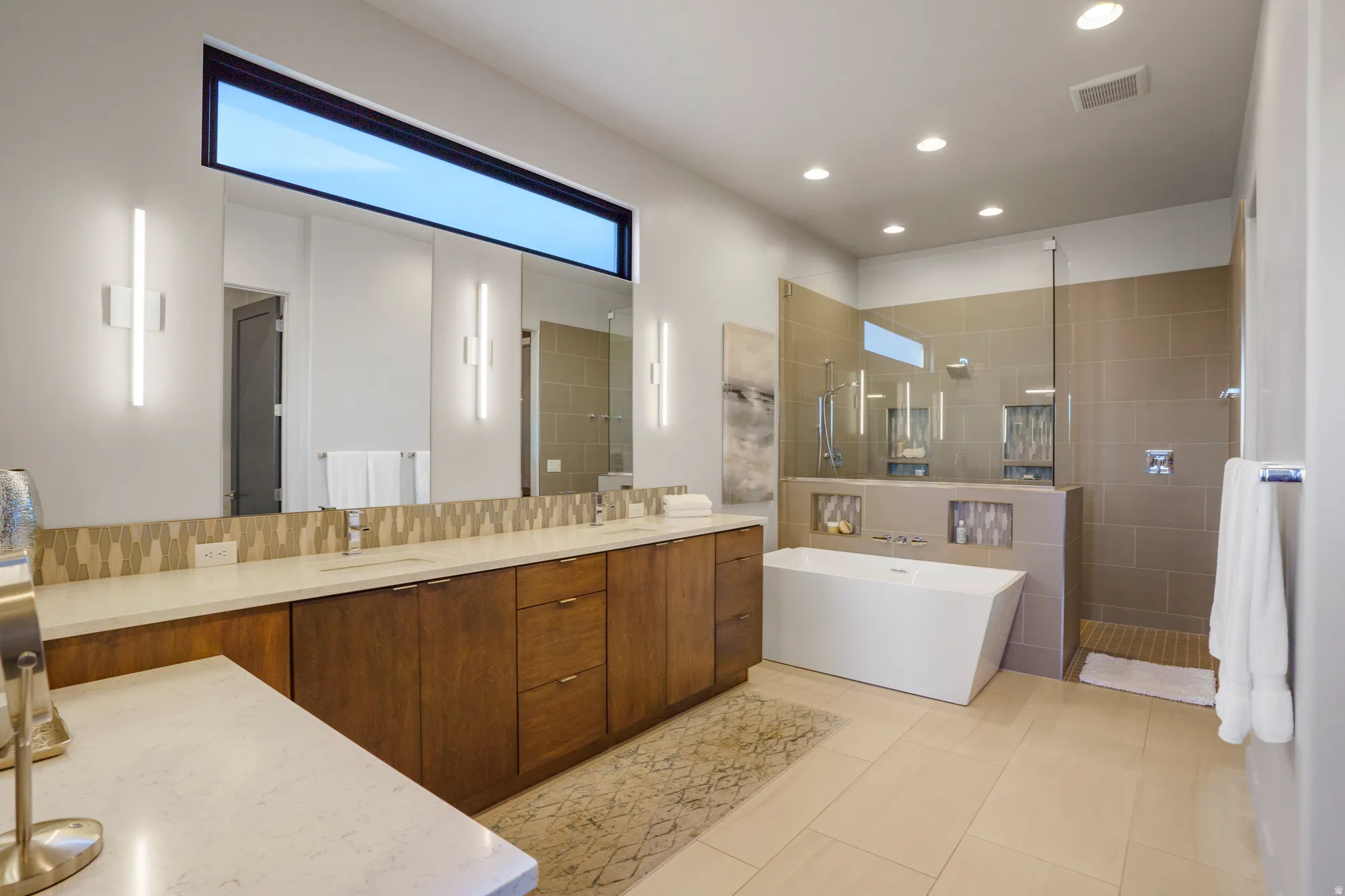 Dual vanity with stone countertops and wood cabinetry