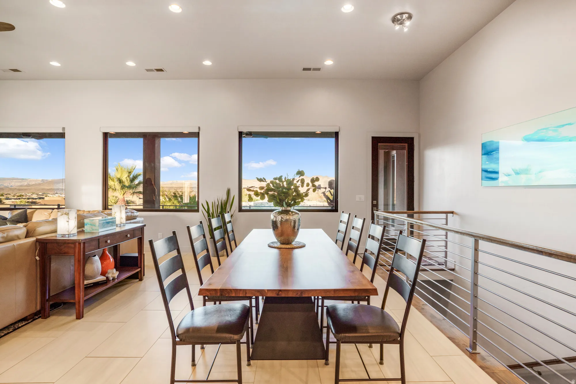 Recessed lighting illuminates an open-concept living area with tile flooring