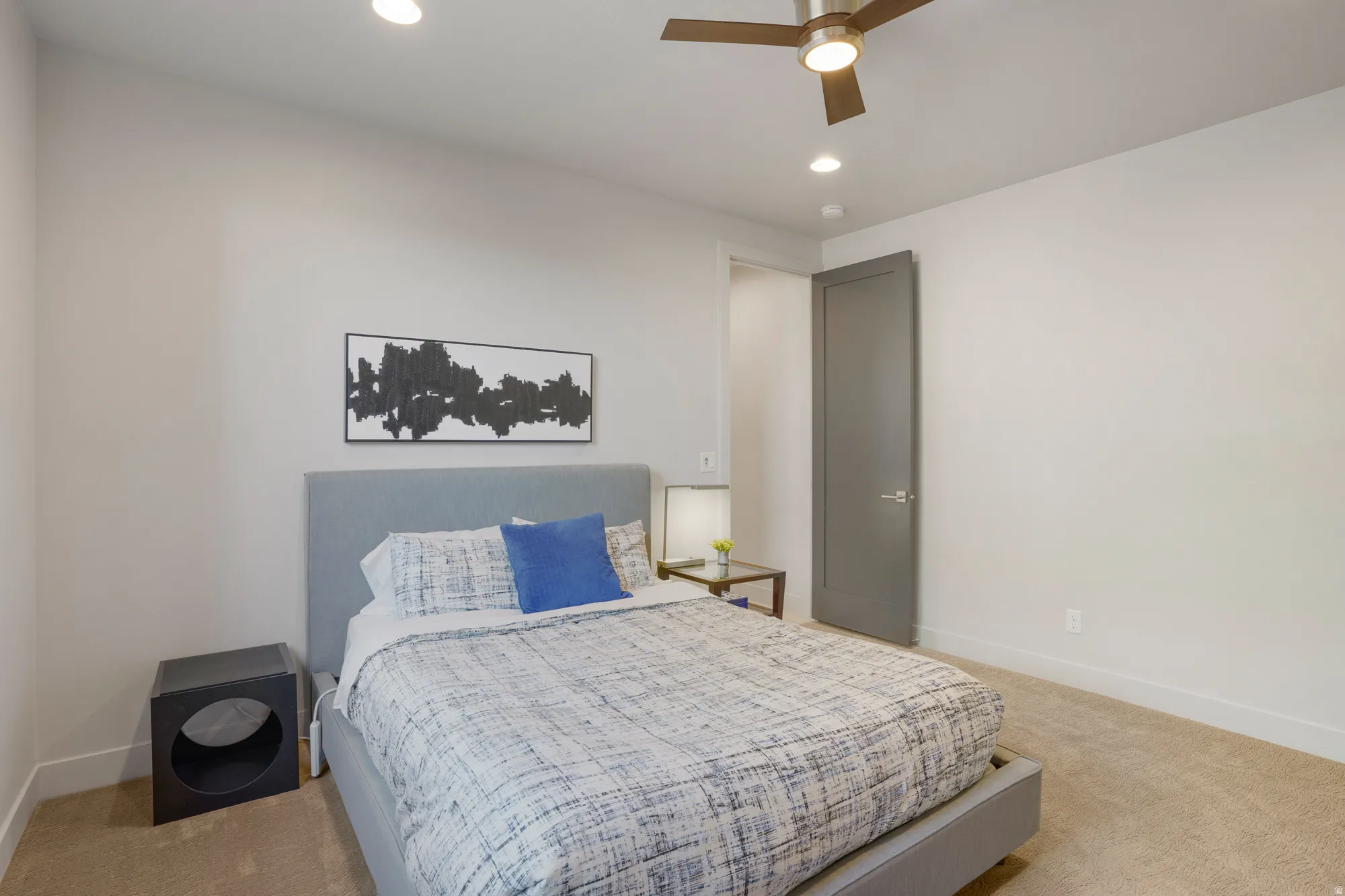 Recessed lighting, ceiling fan with integrated light, warm-toned carpeting, and a flat-panel interior door