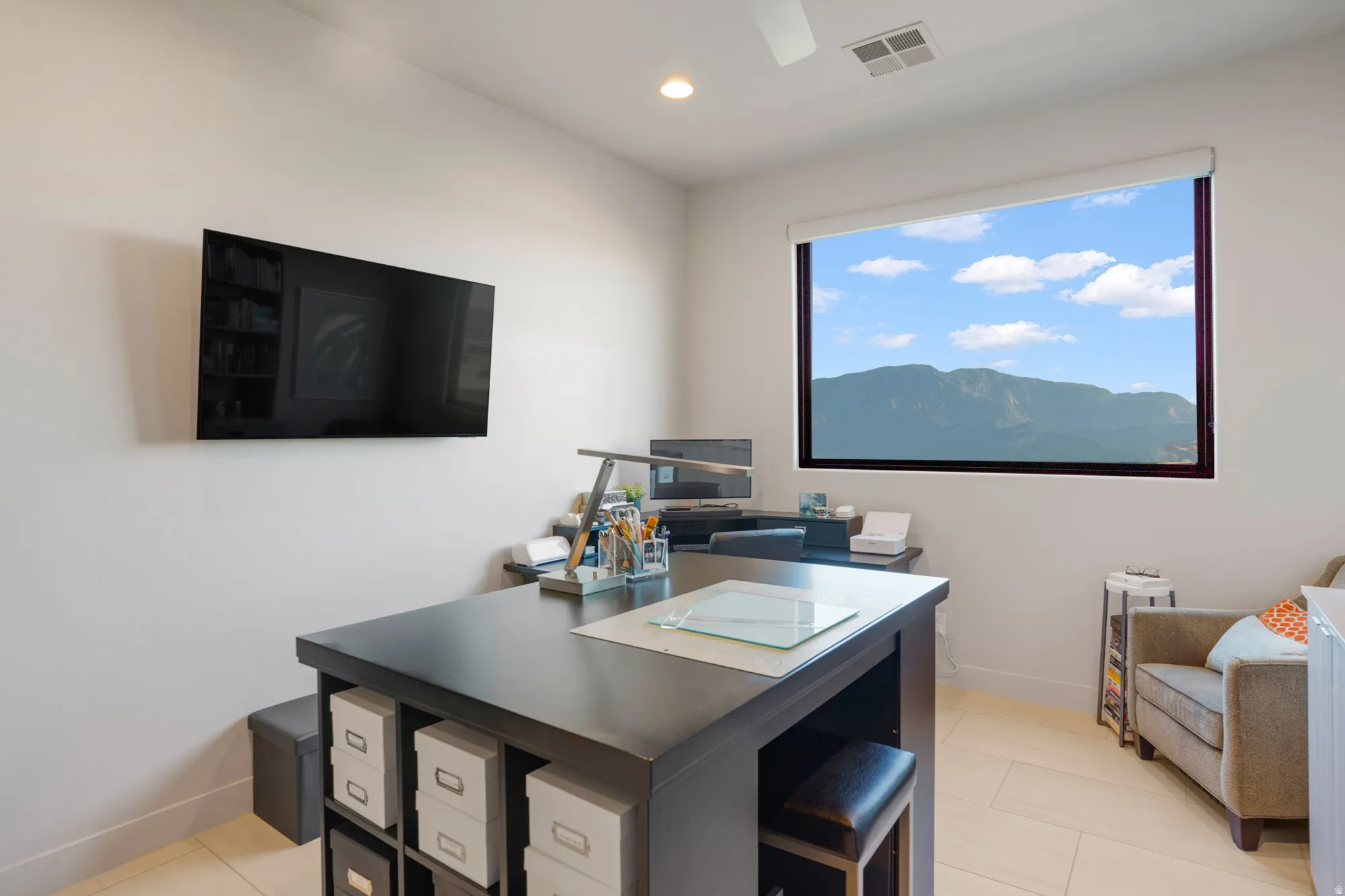 White walls, recessed lighting, ceiling fan, and mountain scenery