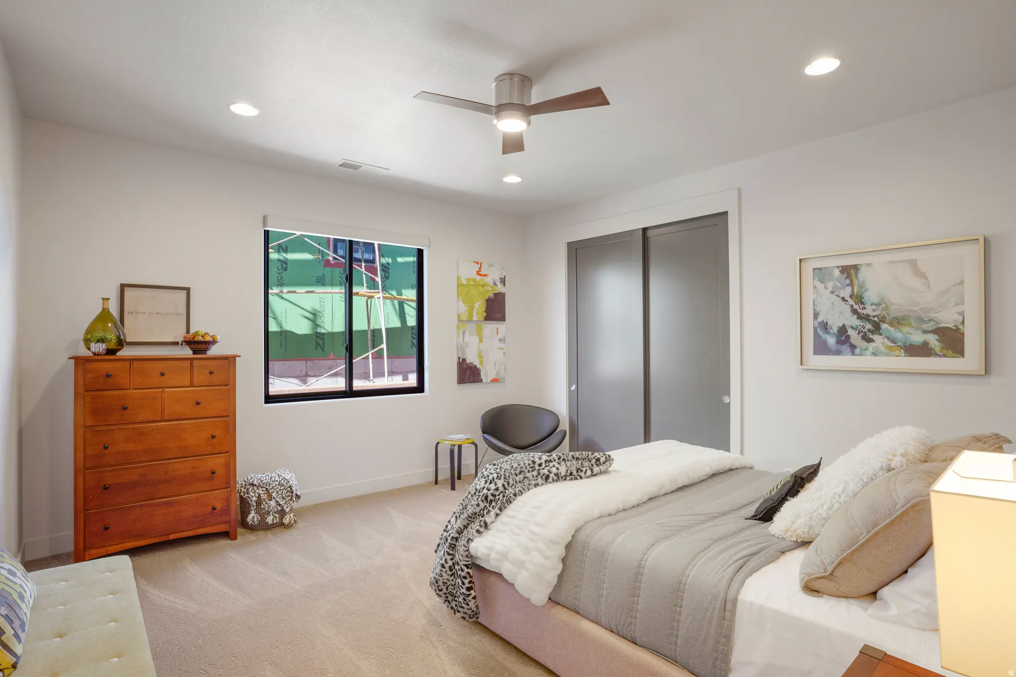 Recessed ceiling lighting, ceiling fan, carpeting, and sliding closet doors