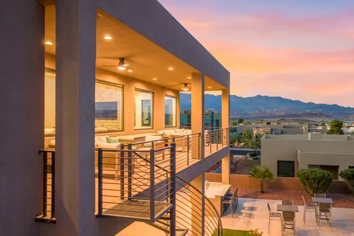 Covered balcony with recessed lighting, ceiling fans, and metal railings
