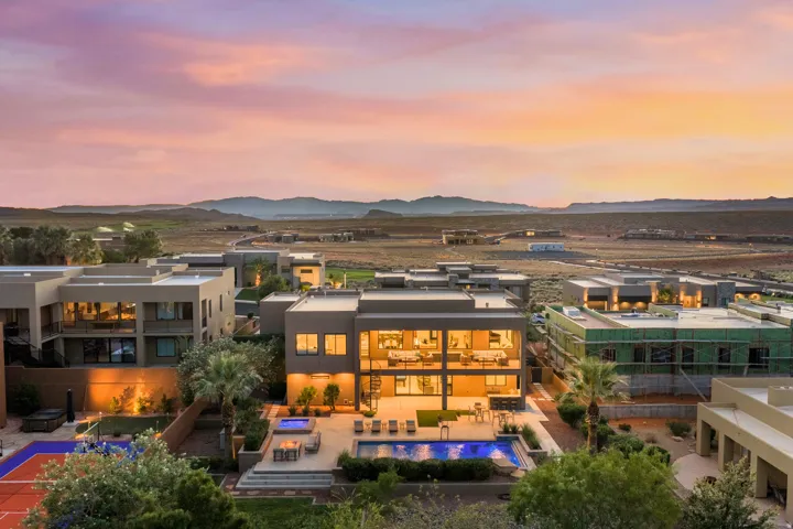 Modern multi-level residence featuring expansive windows, an integrated swimming pool, and a dedicated sports court