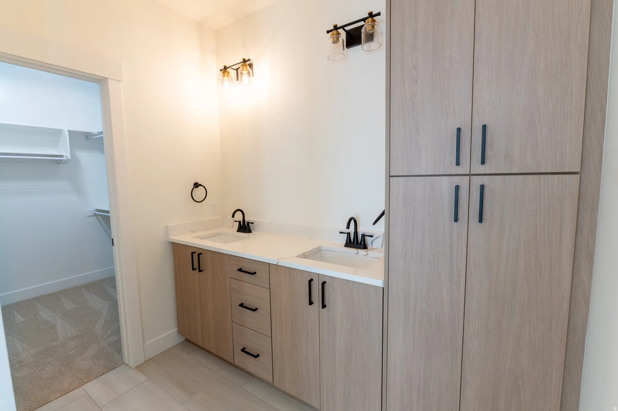 Dual vanity with white countertops, undermount sinks, and matte black fixtures. Master Bathroom