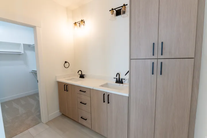 Dual vanity with white countertops, undermount sinks, and matte black fixtures. Master Bathroom