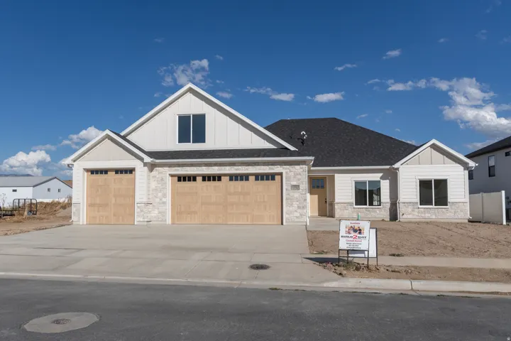 Contemporary exterior featuring stone veneer accents and vertical siding