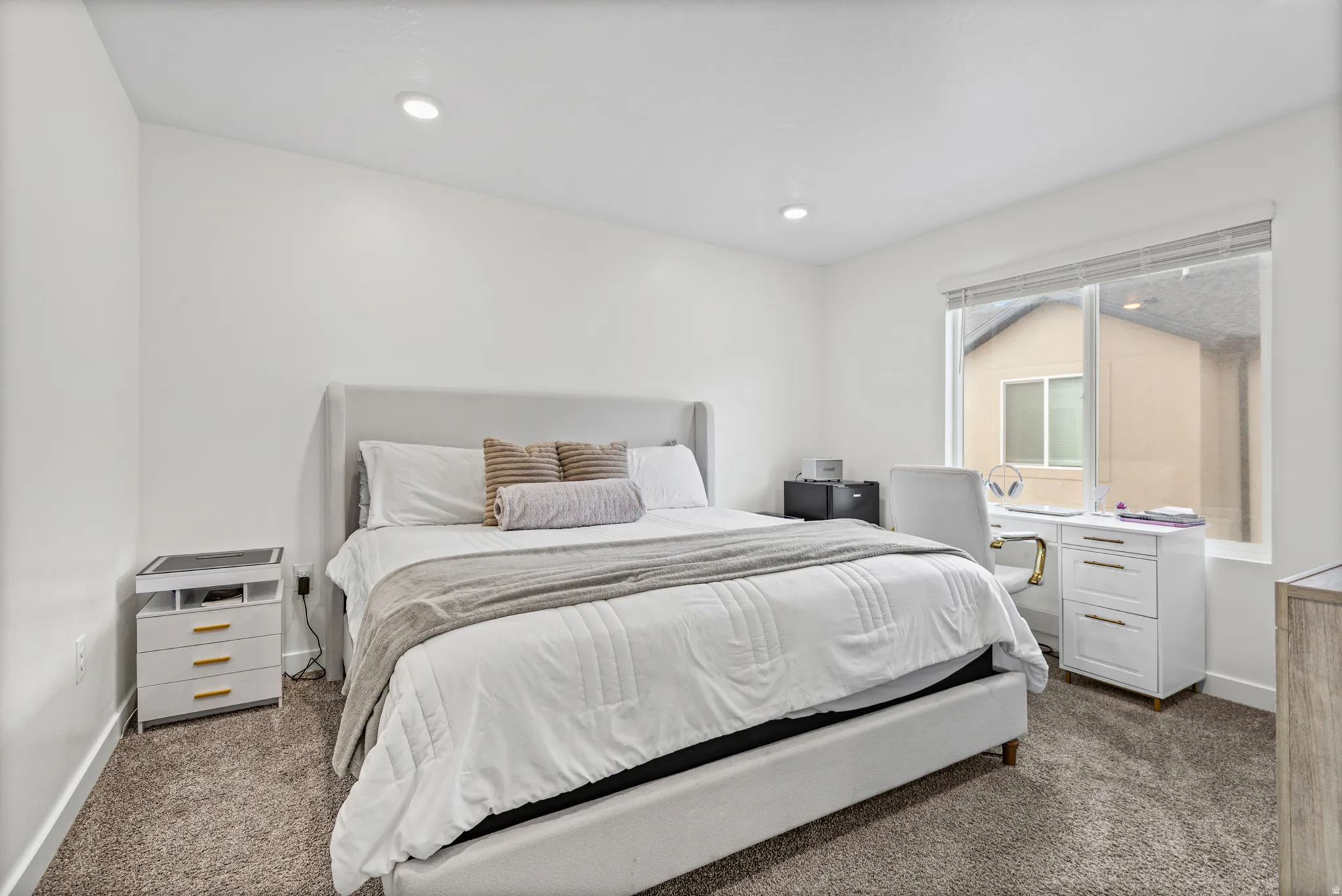 Recessed lighting, large window, and wall-to-wall carpeting