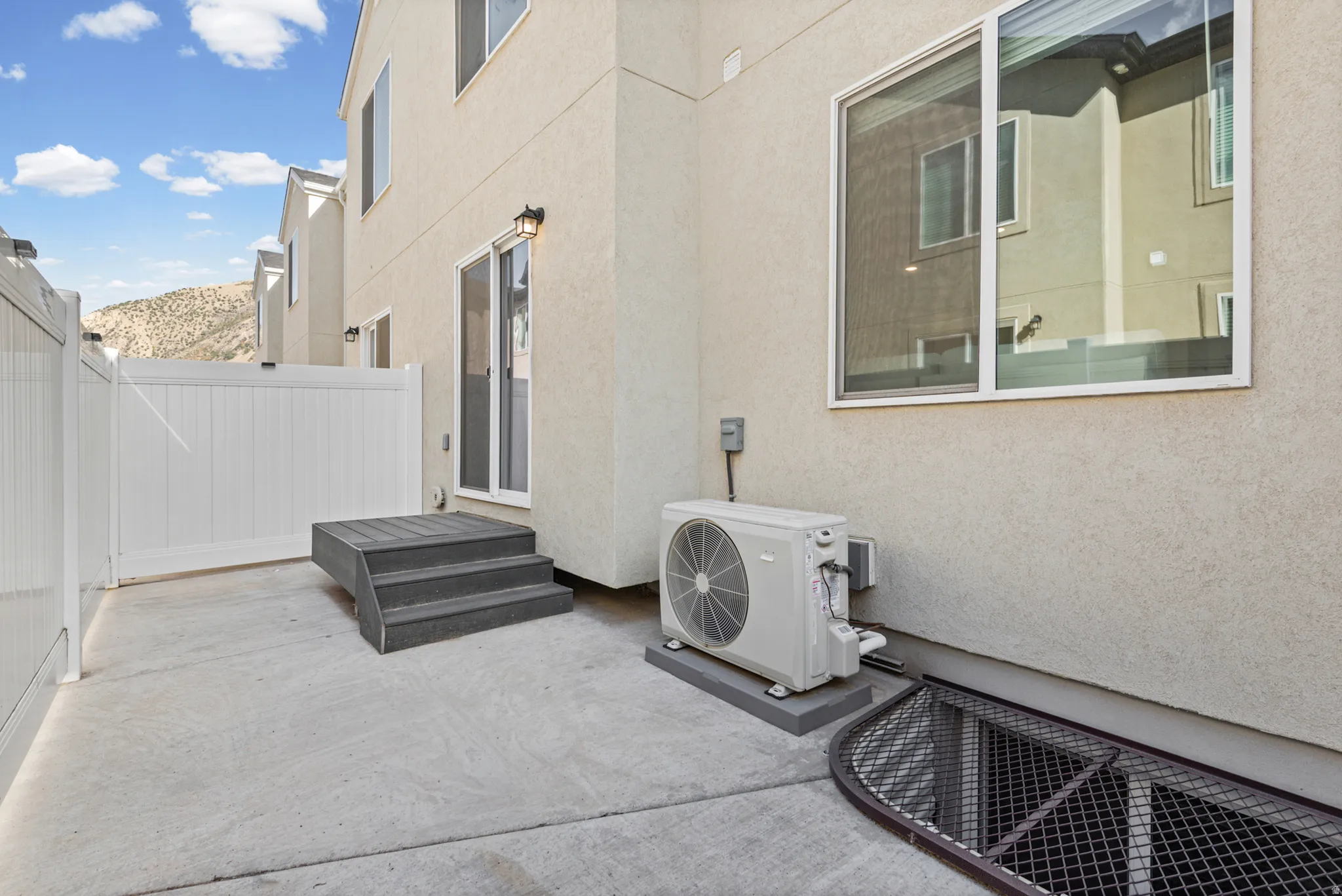 Concrete patio with a white vinyl fence