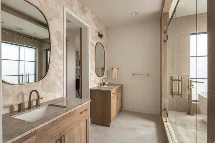 Dual wood-finish vanities with stone countertops