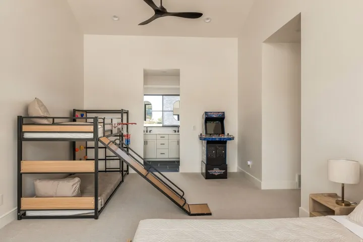 Vaulted ceiling with a ceiling fan, recessed lighting, and soft gray carpeting