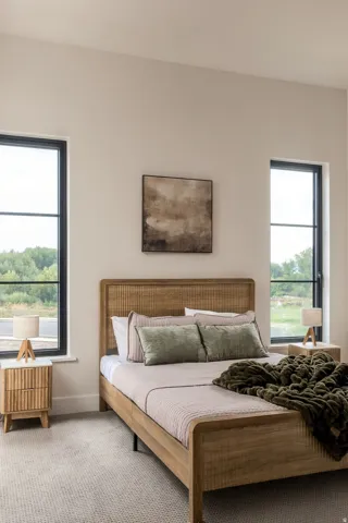 High ceilings with recessed lighting, large windows with dark trim, light-toned wall finishes, and textured carpeting